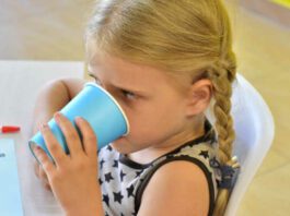 Kindergarten girl drinking at snack time