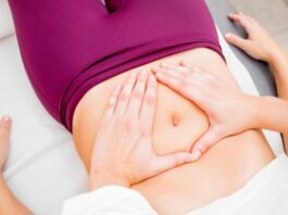woman receiving pelvic floor therapy to her lower stomach while lying on her back