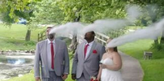 Bride and groom and groomsman vaping in wedding photo