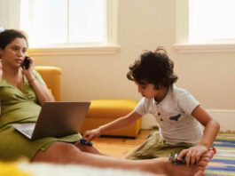 Single mother working in her son's play area