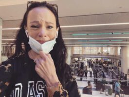 Screenshot of Facebook post woman in airport crying with mask