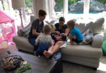 mom with newborn, midwife and older kids sitting on couch