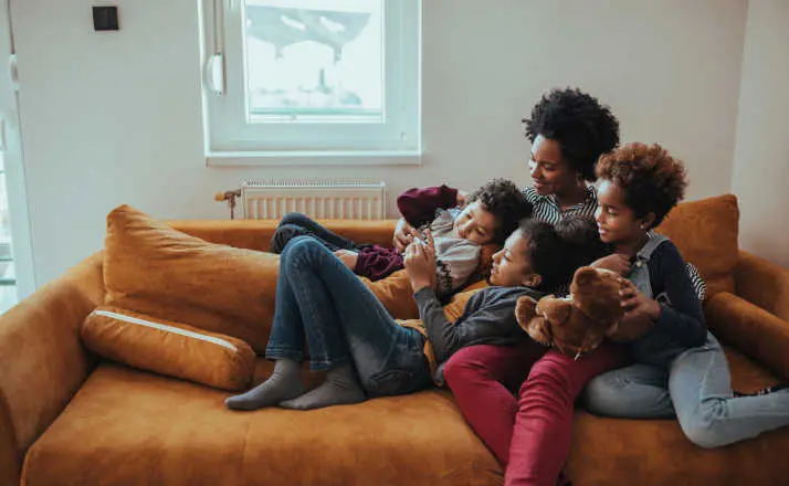 Shot of a mother looking at something on the mobile phone with her children