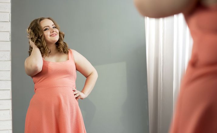 woman smiling in mirror to show how my body image is not for anyone else to judge