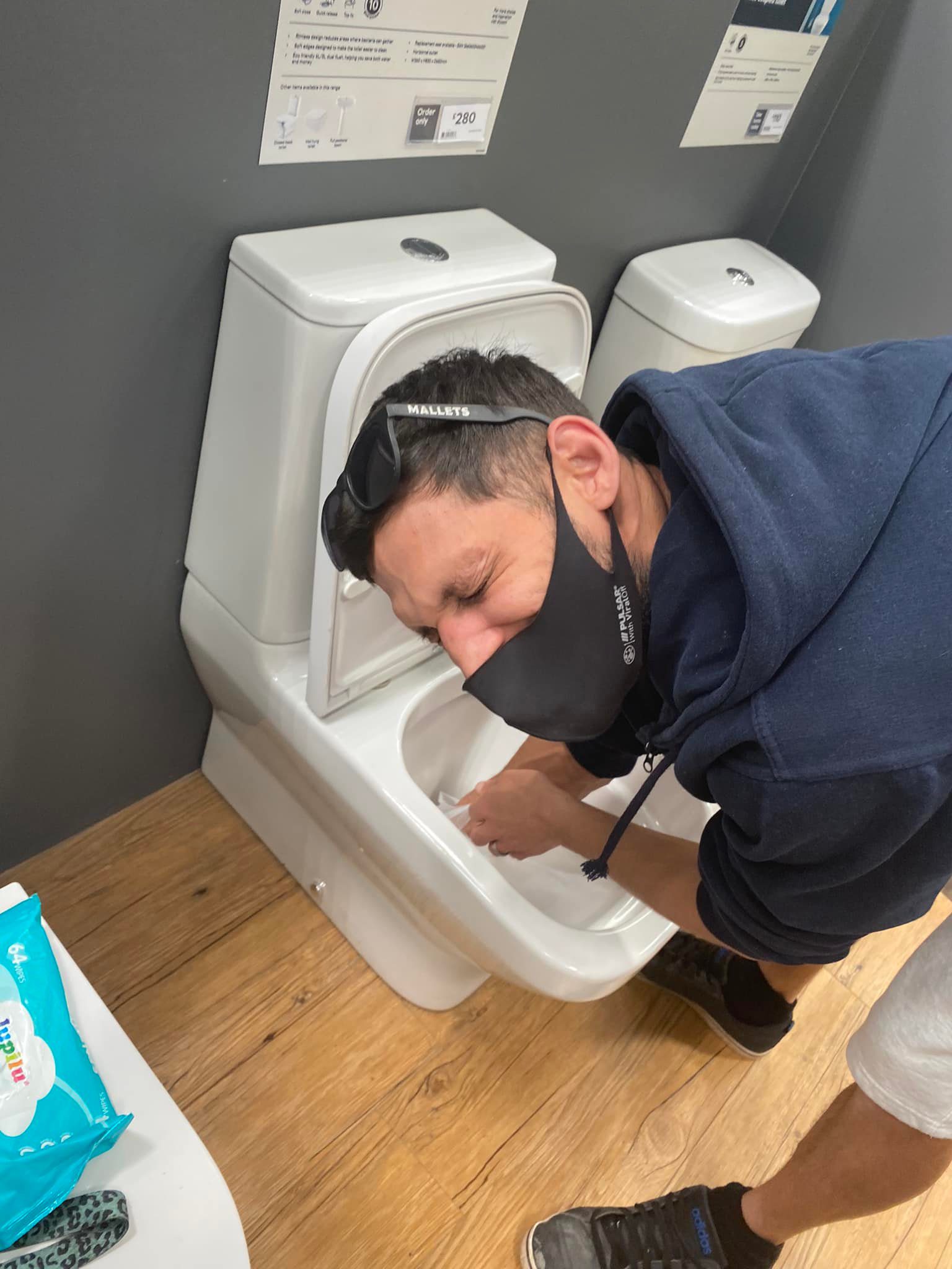 man cleaning out toilet