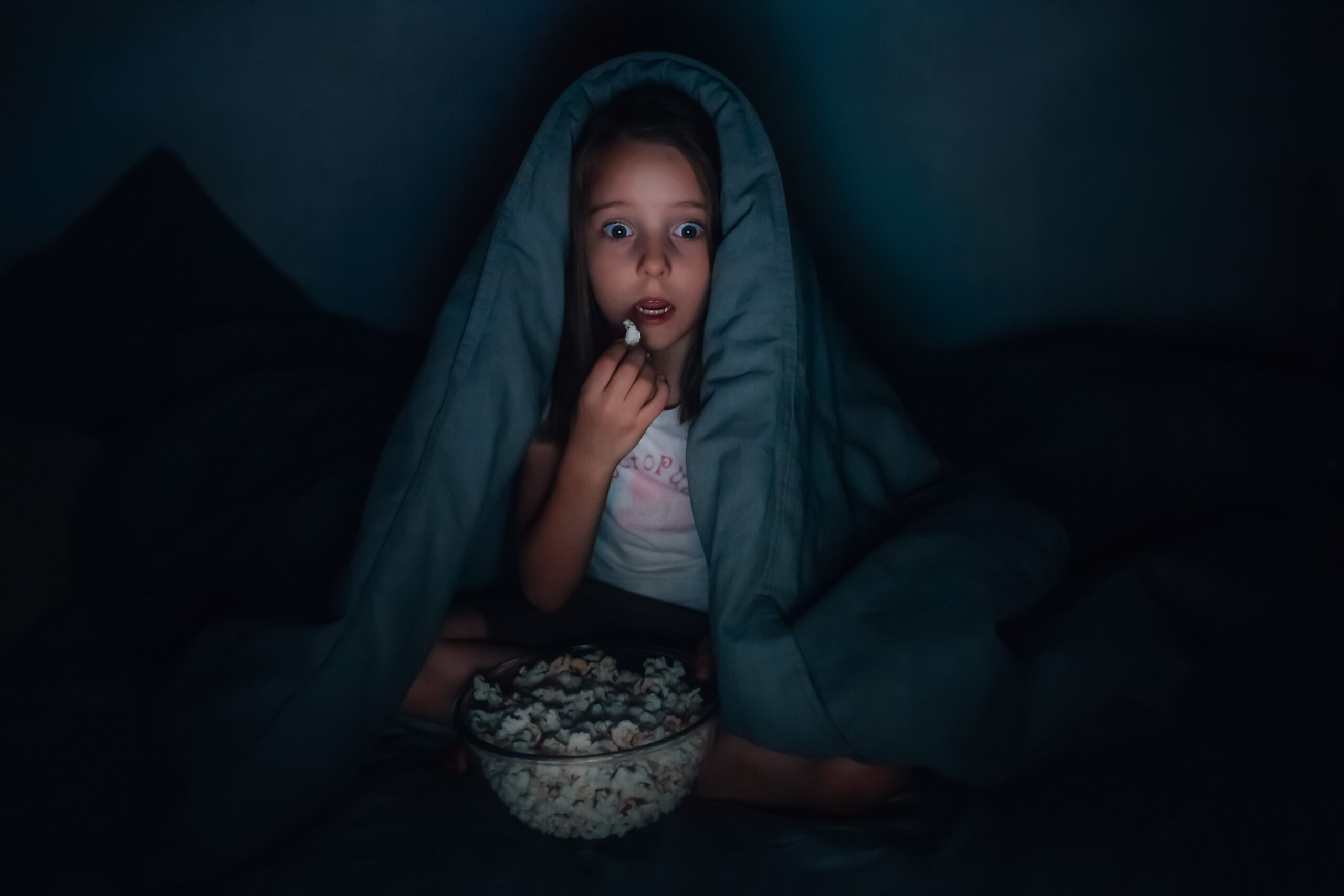 Little girl watches horror movie