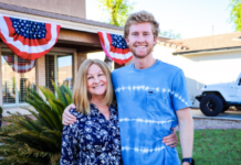 Photo of mother and son standing in front of a house.