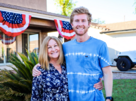 Photo of mother and son standing in front of a house.