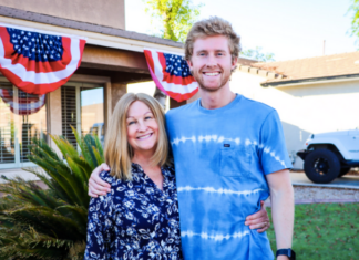 Photo of mother and son standing in front of a house.