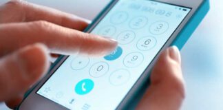 Finger touch number on smartphone to make a call, close up
