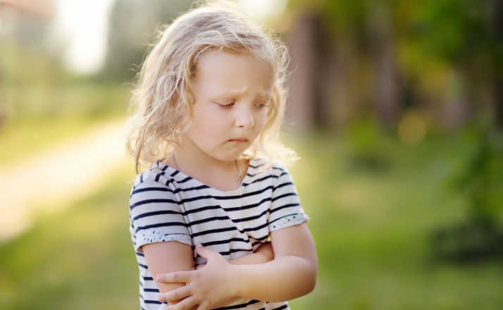 Upset or offended little girl standing on street. overusing the word trauma is a thing.