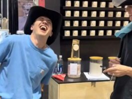 man wincing in pain experiencing period pain simulator