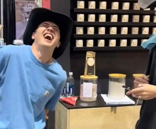 man wincing in pain experiencing period pain simulator