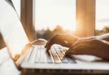 hands typing on keyboard