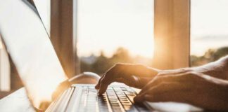 hands typing on keyboard