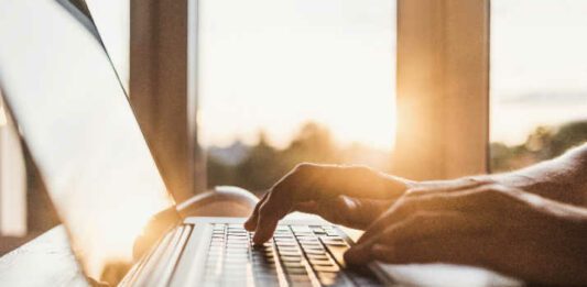 hands typing on keyboard