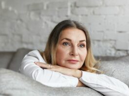 woman looking sad as she experiences grief over her children growing up