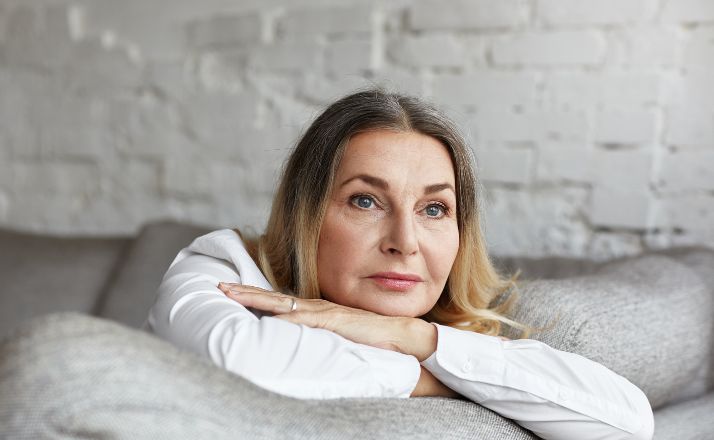 woman looking sad as she experiences grief over her children growing up