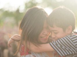 Single mom walking with son together with happy face