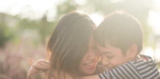 Single mom walking with son together with happy face