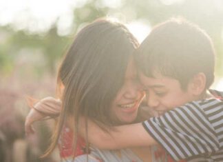 Single mom walking with son together with happy face