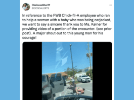 Screenshot of viral Twitter video that shows two people wrestling in a parking lot