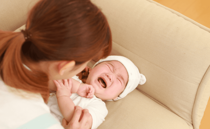 A mother trying to calm her crying baby.