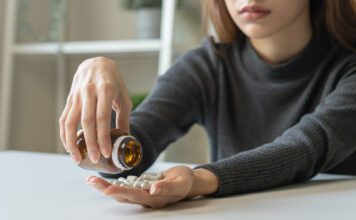 teenage girl with a bottle of pills